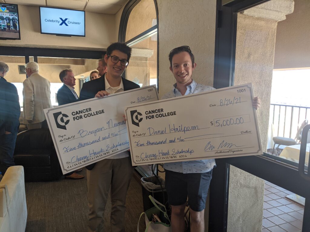 Cherry Hawk Scholars Bryce Newman and Daniel Hailpern hold large $5,000 checks at the 2021 Cherry Hawk Event